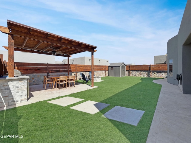 view of yard featuring a storage unit, an outbuilding, area for grilling, a patio, and a fenced backyard