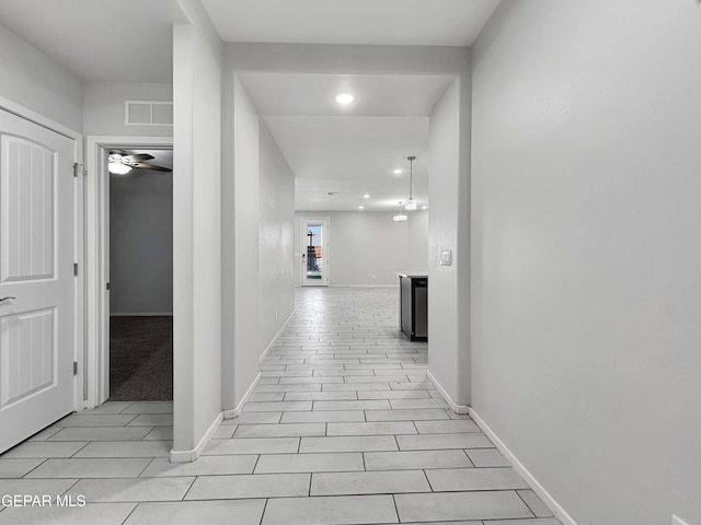 corridor with recessed lighting, visible vents, and baseboards