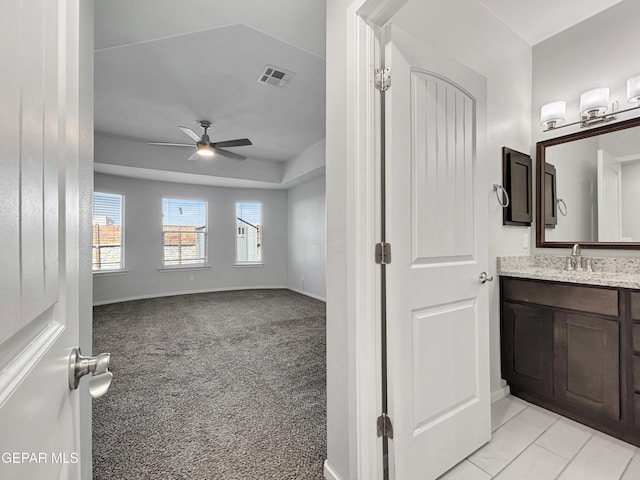 bathroom with tile patterned floors, visible vents, a ceiling fan, baseboards, and vanity