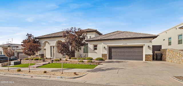 view of front facade with concrete driveway, stone siding, an attached garage, and stucco siding