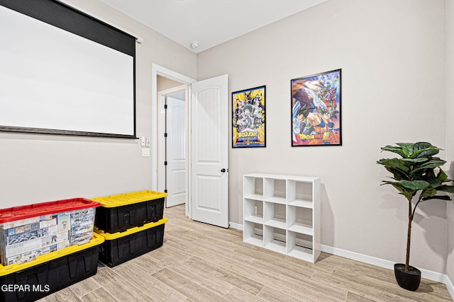 interior space featuring baseboards and wood finished floors