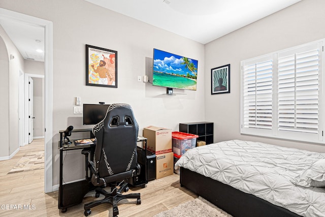 bedroom with wood finished floors and baseboards