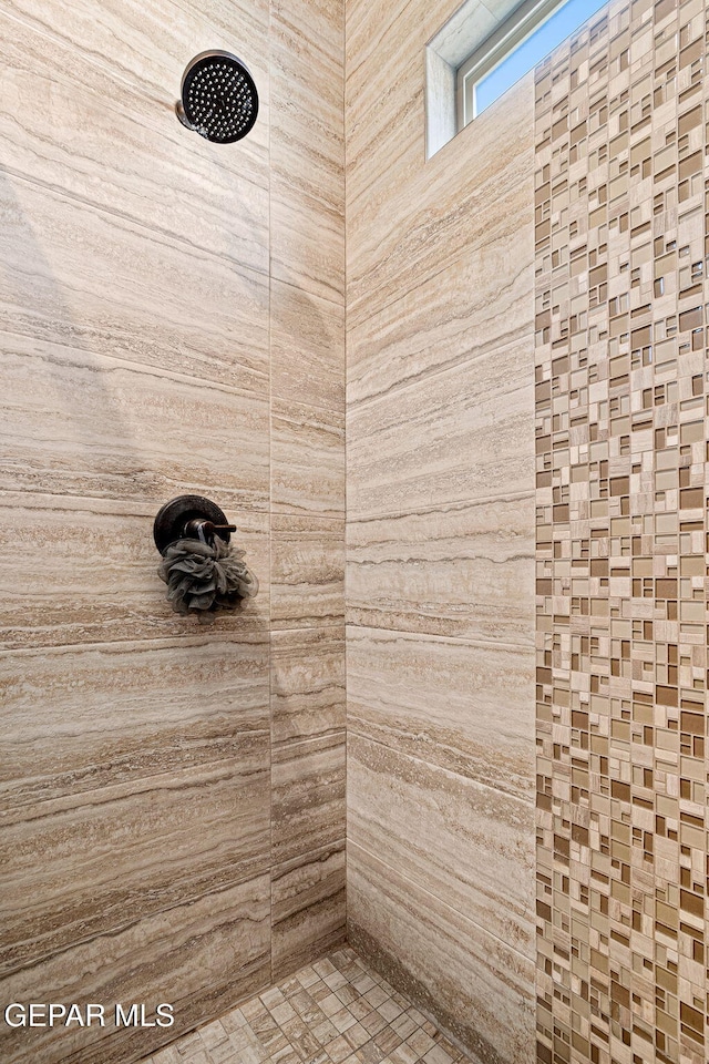 bathroom with a tile shower