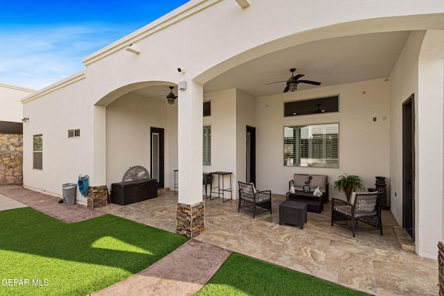 view of patio / terrace with a ceiling fan and an outdoor living space