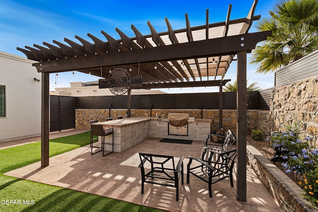 view of patio / terrace with fence private yard, outdoor dry bar, an outdoor kitchen, and a pergola