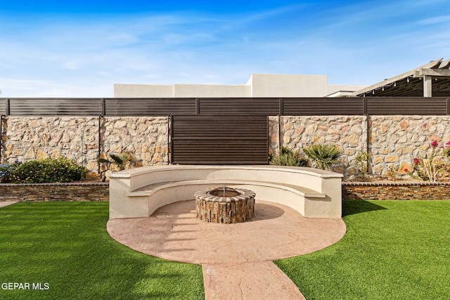 view of patio featuring fence and a fire pit