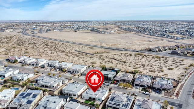 drone / aerial view featuring a desert view and a residential view