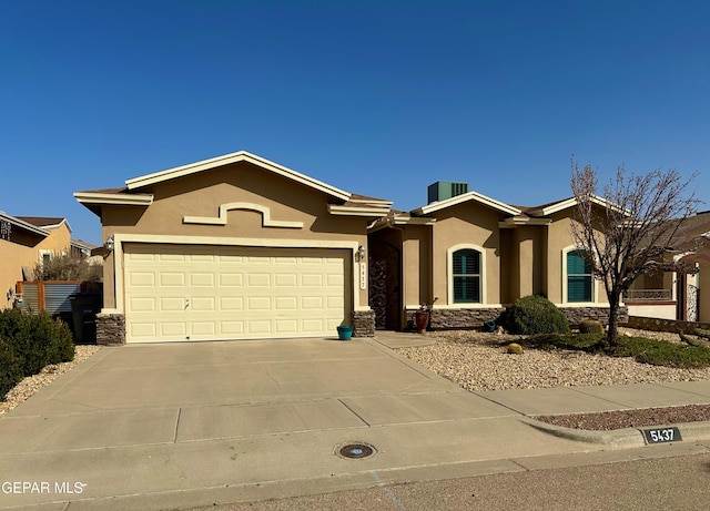 ranch-style house featuring an attached garage, stone siding, driveway, and stucco siding