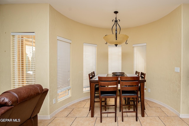 dining space with baseboards and light tile patterned floors