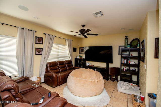 tiled living room featuring visible vents and a ceiling fan