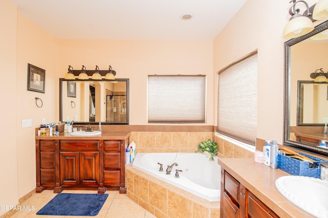 full bath featuring a garden tub, two vanities, tile patterned flooring, and a sink