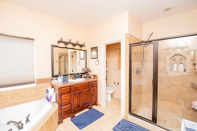 full bath featuring a garden tub, toilet, a shower stall, vanity, and tile patterned flooring