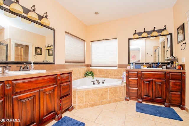 bathroom featuring tile patterned flooring, a sink, a bath, and a shower stall