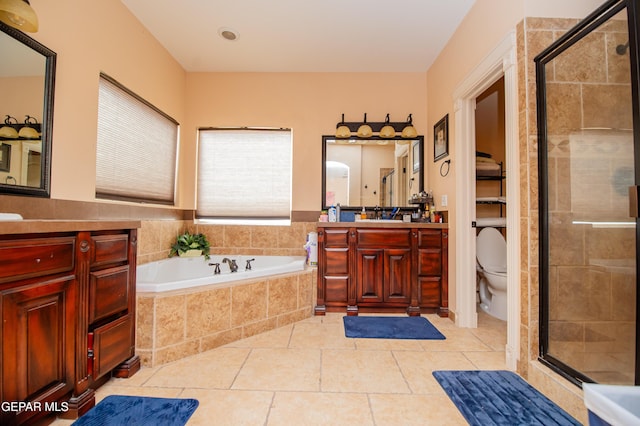 bathroom featuring a garden tub, a shower stall, and tile patterned floors