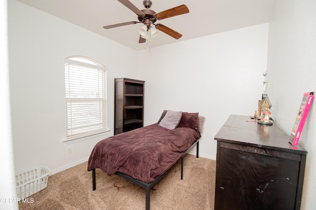 carpeted bedroom featuring a ceiling fan and baseboards