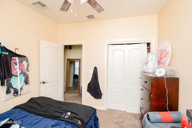 carpeted bedroom with baseboards, a closet, visible vents, and a ceiling fan