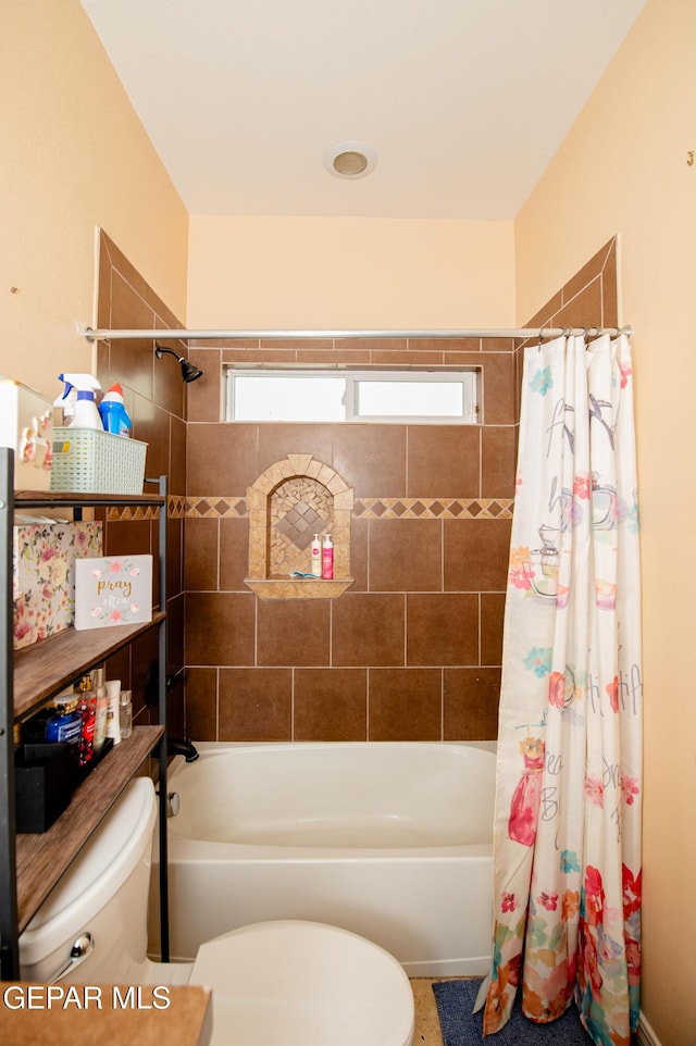 full bathroom with toilet and shower / bath combo with shower curtain