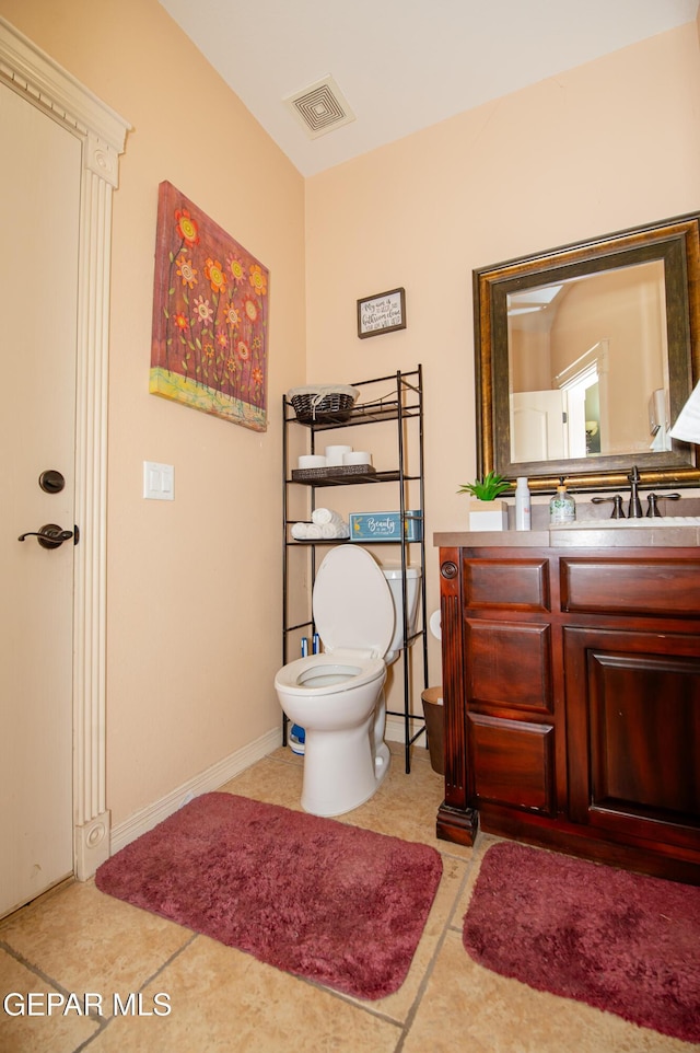 half bath featuring toilet, baseboards, visible vents, and vanity