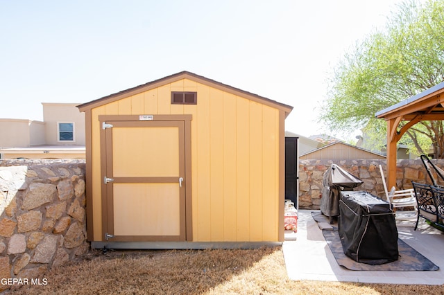 view of shed featuring fence