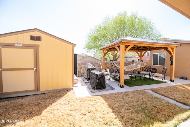 view of patio featuring visible vents, a gazebo, fence, a storage unit, and an outdoor structure