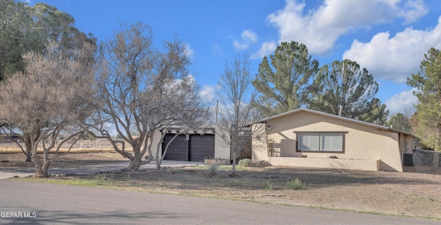 view of front of property featuring a garage and stucco siding