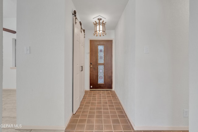 entryway featuring tile patterned floors and a barn door