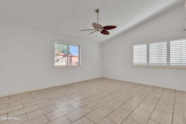 empty room featuring a ceiling fan and vaulted ceiling