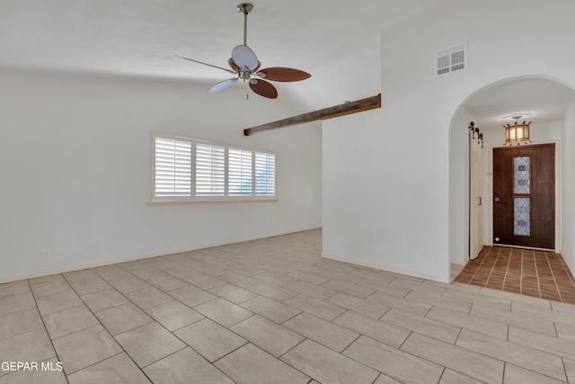 tiled spare room with visible vents, arched walkways, a ceiling fan, and vaulted ceiling