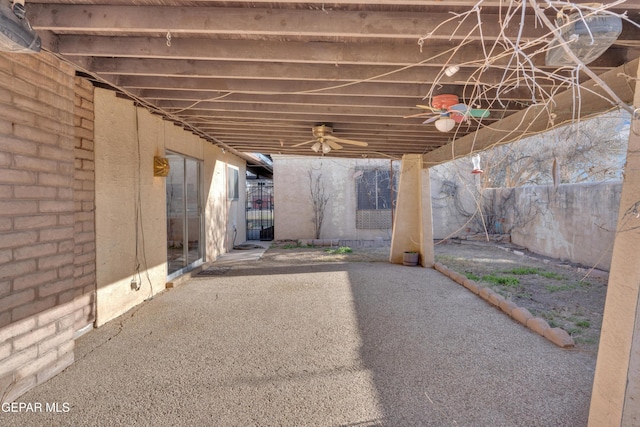 view of patio featuring ceiling fan and fence