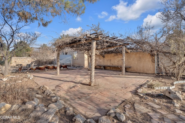 exterior space featuring a patio area and a pergola