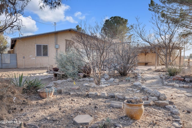 back of property with stucco siding