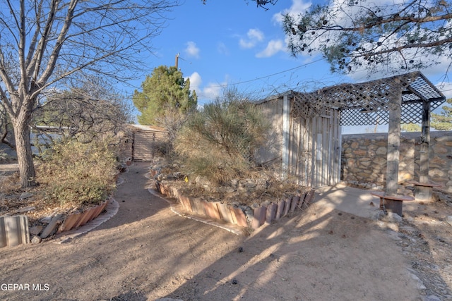 view of yard with a shed, an outdoor structure, and fence