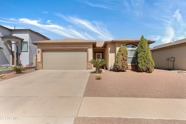 view of front of house featuring a garage, driveway, and stucco siding