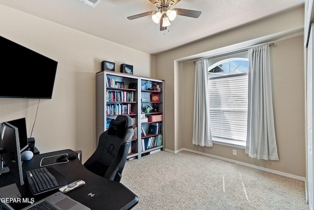 carpeted office with baseboards and ceiling fan