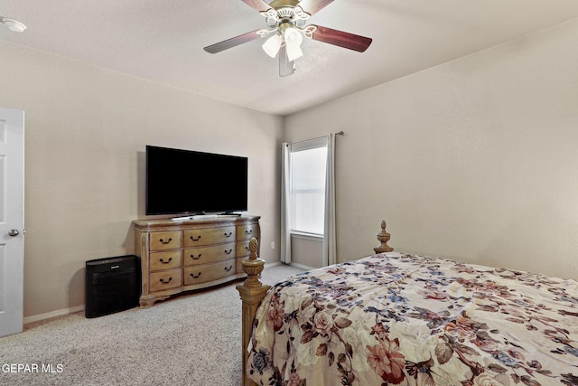 carpeted bedroom with baseboards and a ceiling fan