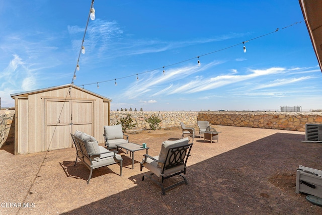 view of patio / terrace featuring an outdoor structure, central AC, fence, and a shed