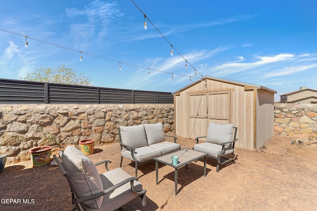 view of patio / terrace featuring a shed, an outdoor structure, outdoor lounge area, and a fenced backyard