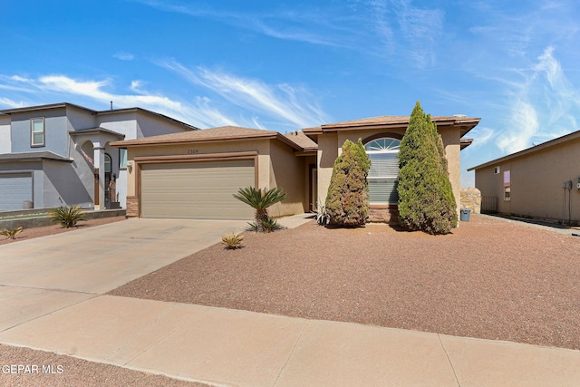 view of front of property with a garage, driveway, and stucco siding