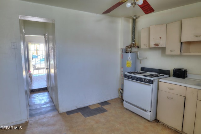 kitchen featuring a ceiling fan, light floors, water heater, light countertops, and white gas range