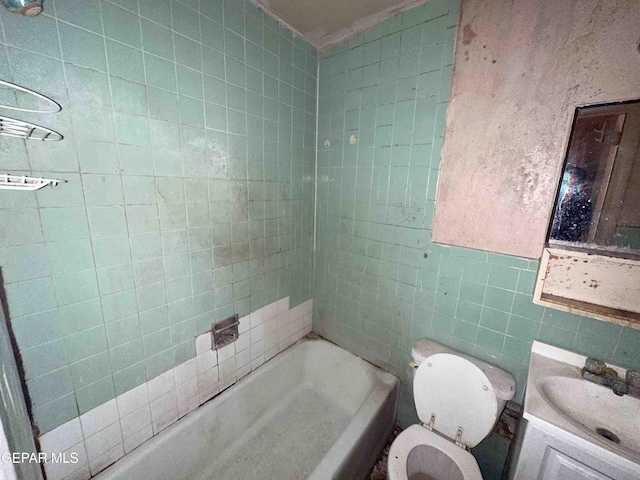 full bath with toilet, tile walls, and vanity