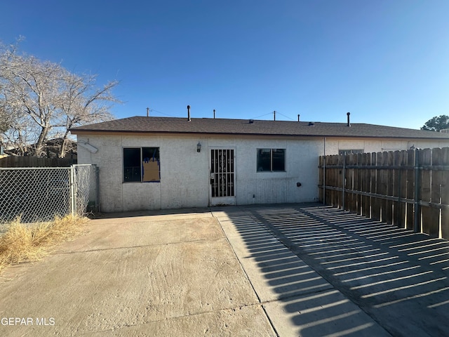 back of property featuring stucco siding, a patio, and fence