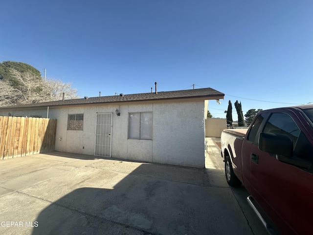 back of house with stucco siding, a patio area, and fence