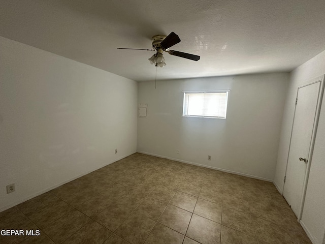 unfurnished room with tile patterned floors, a textured ceiling, and ceiling fan