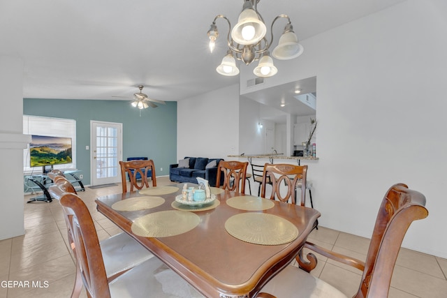 dining room featuring lofted ceiling, light tile patterned floors, ceiling fan with notable chandelier, and visible vents