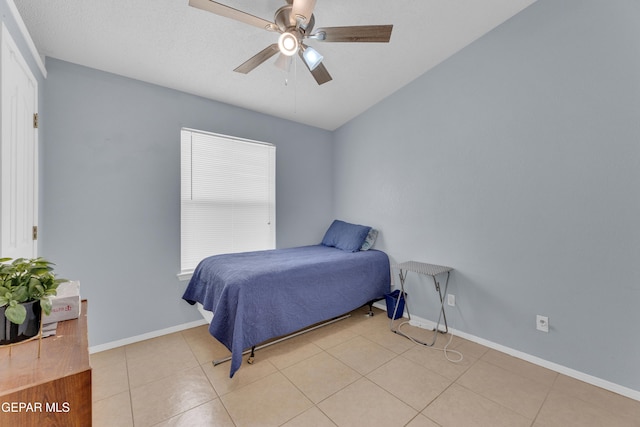 bedroom with light tile patterned floors, baseboards, and a ceiling fan