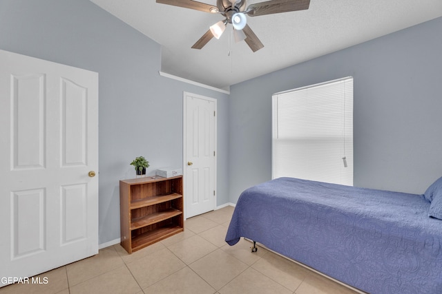 bedroom with light tile patterned floors, baseboards, and ceiling fan