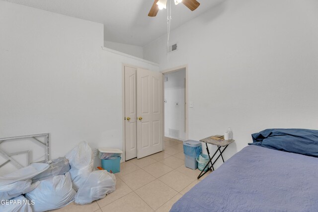 bedroom featuring tile patterned floors, visible vents, ceiling fan, and vaulted ceiling