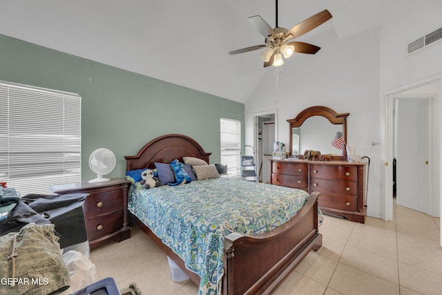 bedroom with high vaulted ceiling, light tile patterned floors, visible vents, and ceiling fan