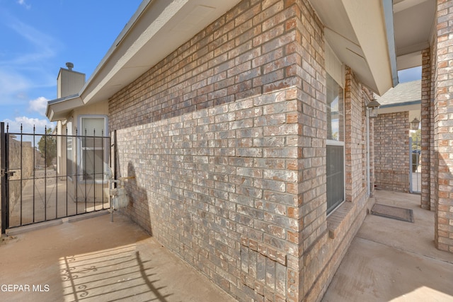 view of side of home featuring brick siding