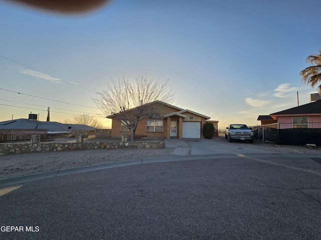 view of front facade featuring concrete driveway and an attached garage